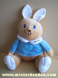 Doudou Lapin Chicco Beige pull bleu avec un coeur bleu en plastique A une poche vide fermée par velcro dans son dos