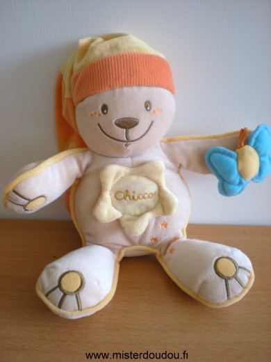 Doudou Ours Chicco Beige bonnet jaune orange papillon bleu sur la main 