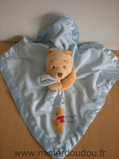 Doudou Ours Disney Winnie jaune tenant mouchoir bleu liseret satin 