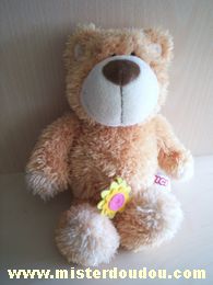 Doudou Ours Nici Beige Avec une petite fleur en feutrine qui sort du ventre