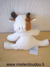 Doudou Vache Comptine Tissus eponge blanc marron Très bon état général sauf une petite tache sur la patte.