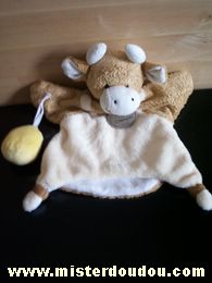 Doudou Vache Doudou et compagnie Marron / ecru Elle a un sac jaune.