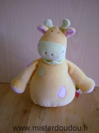 Doudou Vache Tex Jaune vert rose foulard vert Manque la tirette au bout de la ficelle, queue un peu décousue, le reste est en bon état